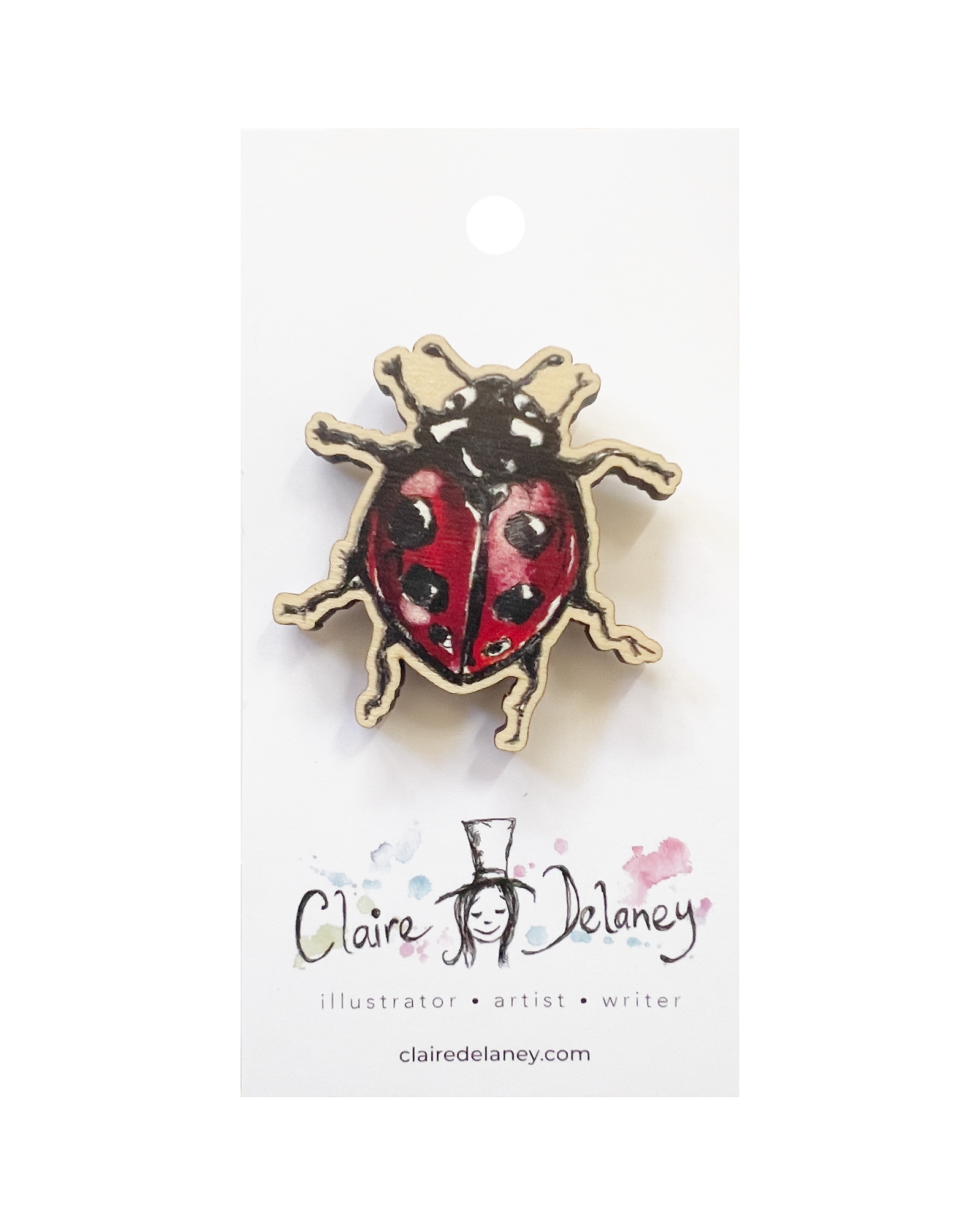 Ladybird Wooden Pin Badge featuring Claire Delaney artwork on its display card