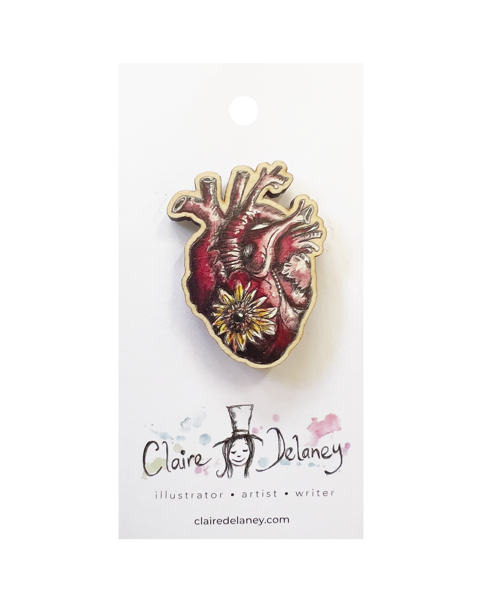 Heart wooden pin badge featuring Claire Delaney artwork on its display card